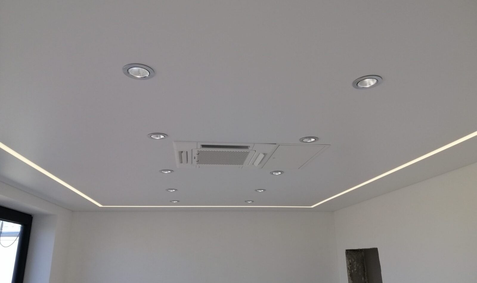 Matte Akustik-Spanndecke im Büro mit integrierten LED-Spots und Lichtlinien